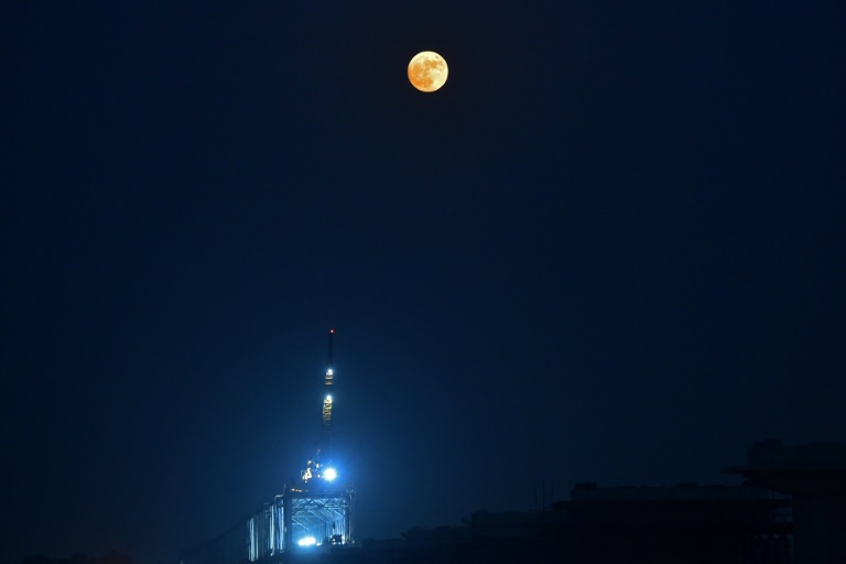 The Blue supermoon rises over the river Ganges, in Prayagraj on August 30, 2023 .