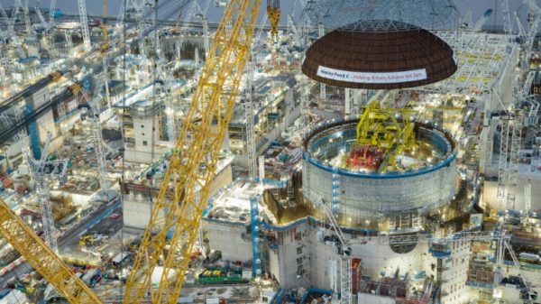An EDF handout showing the steel dome being installed over Hinkley Point C's reactor 1
