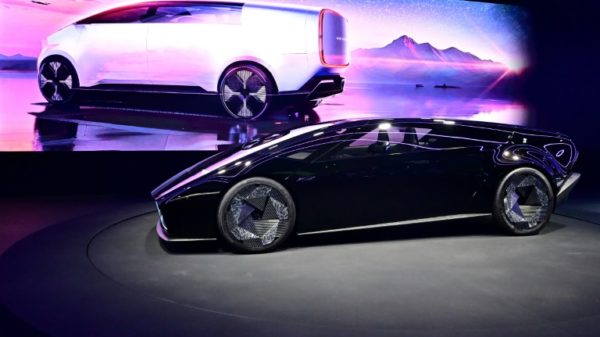 Japanese automaker Honda unveils two new electric vehicle concepts, the Saloon (foreground) and Space-Hub (on screen) during the Consumer Electronics Show (CES) in Las Vegas, Nevada on January 9, 2024