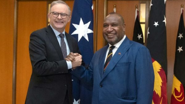 Papua New Guinea Prime Minister James Marape (R) shakes hands with Australian Prime Minister Anthony Albanese in Canberra on Thursday