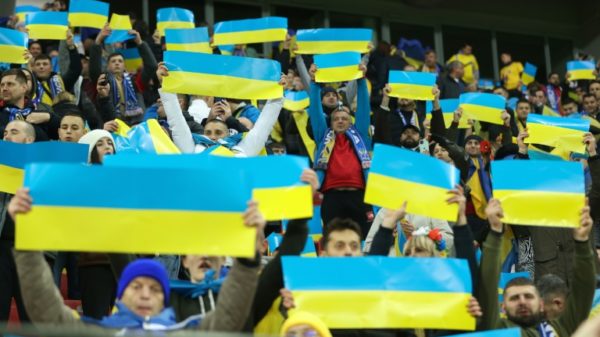 Supporters hold up Ukraine flags at the Euro 2024 qualifier against Italy last month