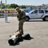 A police expert examines fragments of a downed missile after Russia fired a barrage at Kyiv for the second time in 24 hours