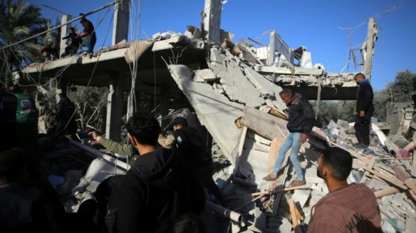 Palestinians inspect the rubble of a house in Deir al-Balah on Tuesday after an Israeli strike