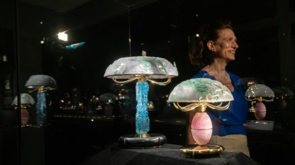 Carole Chervin, daughter of French jeweller Andre Chervin, stands next to works by her father and his New York atelier Carvin French