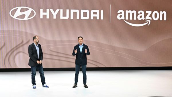 Amazon Vice President Marty Mallick (L) and Hyundai Global President Jose Munoz speak at the media preview day for the Los Angeles Auto Show, on November 16, 2023