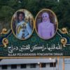 Portraits of Prince Abdul Mateen (L) and bride Yang Mulia Anisha Rosnah adorn a billboard over a road in Brunei ahead of their wedding